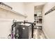 Functional laundry room featuring modern appliances, storage shelves, and sleek flooring at 391 Capistrano Vistas St, Las Vegas, NV 89138