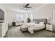 Relaxing main bedroom featuring a king bed, comfortable seating, and neutral decor at 391 Capistrano Vistas St, Las Vegas, NV 89138