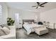 Bright bedroom with a king bed, seating area, natural light, and neutral decor at 391 Capistrano Vistas St, Las Vegas, NV 89138