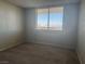 Bedroom with large window, carpeted floor and bright natural light at 3930 University Center Dr # 901, Las Vegas, NV 89119