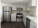 Updated kitchen with stainless steel appliances, white cabinets, and marbled countertops at 3930 University Center Dr # 901, Las Vegas, NV 89119