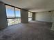 Large living area with cityscape views through expansive windows at 3930 University Center Dr # 901, Las Vegas, NV 89119