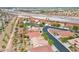 Aerial view of a community with tile roofs, desert landscaping and street lined trees at 4029 Ricebird Way, North Las Vegas, NV 89084