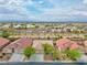 A high angle aerial shot showcases the community, landscaping and tiled home roofs at 4029 Ricebird Way, North Las Vegas, NV 89084