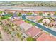 An aerial view shows a community with many tile roofs, landscaping and a windy street at 4029 Ricebird Way, North Las Vegas, NV 89084