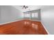 Spacious bedroom featuring hardwood floors, a ceiling fan, and a bay window with shutter blinds at 4029 Ricebird Way, North Las Vegas, NV 89084