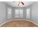 Bright bedroom features three windows, tile floor, neutral walls, and ceiling fan at 4029 Ricebird Way, North Las Vegas, NV 89084