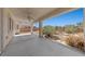 Spacious covered patio with concrete flooring and views of the desert landscaping at 4029 Ricebird Way, North Las Vegas, NV 89084