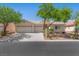 Charming single-story home with a tile roof, mature trees, and a spacious three-car garage at 4029 Ricebird Way, North Las Vegas, NV 89084