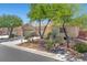 Charming single-story home with a tile roof, mature trees, and a well-maintained front yard at 4029 Ricebird Way, North Las Vegas, NV 89084