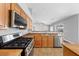 Modern kitchen with granite countertops, a stainless steel sink and appliances, and a gas range at 4029 Ricebird Way, North Las Vegas, NV 89084