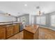 Bright kitchen features tile floor, island, stainless steel appliances, and sliding glass door access to the backyard at 4029 Ricebird Way, North Las Vegas, NV 89084