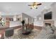 Open-concept living room boasts a cozy fireplace, hardwood floors, and seamless flow to the kitchen at 4029 Ricebird Way, North Las Vegas, NV 89084