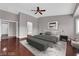 Spacious main bedroom with wood floor, neutral walls, walk-in closet, ceiling fan, and sitting area at 4029 Ricebird Way, North Las Vegas, NV 89084