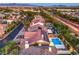 Stunning aerial view of a home with a private pool and solar panels in a vibrant neighborhood with mountain views at 4045 Abernethy Forest Pl, Las Vegas, NV 89141