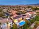 Aerial view showcases a beautiful backyard oasis with a pool and solar panels enhancing this home's appeal at 4045 Abernethy Forest Pl, Las Vegas, NV 89141