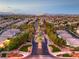 Panoramic aerial view of a meticulously landscaped residential area with tree-lined streets and well-kept homes at 4045 Abernethy Forest Pl, Las Vegas, NV 89141