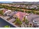 Aerial view of a beautiful home with a red-tiled roof, mature landscaping, and neighborhood view at 4045 Abernethy Forest Pl, Las Vegas, NV 89141