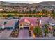 Expansive aerial shot showcasing a luxurious home with a red tile roof and lush landscaping at 4045 Abernethy Forest Pl, Las Vegas, NV 89141