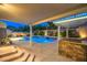Expansive backyard featuring a pool, built-in grill, and shaded pergola at 4045 Abernethy Forest Pl, Las Vegas, NV 89141