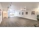 Large basement area with neutral flooring, movie posters, and an exit to the yard at 4045 Abernethy Forest Pl, Las Vegas, NV 89141