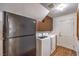 Functional laundry area equipped with a washer, dryer, refrigerator, and storage cabinets at 4045 Abernethy Forest Pl, Las Vegas, NV 89141