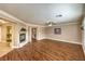 Large living area includes fireplace, wood floors, crown molding and neutral colored walls at 4045 Abernethy Forest Pl, Las Vegas, NV 89141