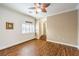 Neutral living room with hard wood floors, high ceilings, a ceiling fan, and plantation shutters at 4045 Abernethy Forest Pl, Las Vegas, NV 89141