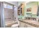 Bathroom features shower-over-tub, modern vanity with decorative lighting, and granite counters at 4095 Ridgewood Ave, Las Vegas, NV 89120