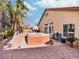 Backyard featuring a spa, gravel landscaping, and multiple chairs at 4314 Livorno Ave, Las Vegas, NV 89141