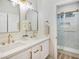 Elegant bathroom with double vanity, marble countertops, and a glass-enclosed shower, offering a spa-like experience at 4314 Livorno Ave, Las Vegas, NV 89141