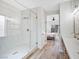 Modern bathroom features a glass shower with gold accents, wood floors, and double vanity at 4314 Livorno Ave, Las Vegas, NV 89141