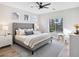 A bright bedroom features a large window, a tufted headboard, and modern decor at 4314 Livorno Ave, Las Vegas, NV 89141