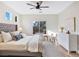 Bedroom featuring a queen bed with a tufted headboard, a large window, and simple decor at 4314 Livorno Ave, Las Vegas, NV 89141