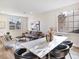 Open dining area features a long marble table and black leather chairs with plenty of sunlight at 4314 Livorno Ave, Las Vegas, NV 89141