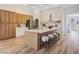 Bright kitchen with wood floors, a large island with seating, and stainless steel appliances at 4314 Livorno Ave, Las Vegas, NV 89141