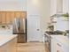 Modern kitchen featuring stainless steel appliances, wood cabinets, and a white backsplash at 4314 Livorno Ave, Las Vegas, NV 89141