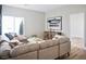 Bright living room featuring a large sectional sofa, wood floors, and modern decor at 4314 Livorno Ave, Las Vegas, NV 89141