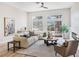 Bright and airy living room featuring modern furnishings, natural light, and backyard access at 4314 Livorno Ave, Las Vegas, NV 89141