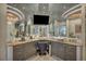 A luxurious bathroom vanity with granite counters, a sleek vessel sink, a wall-mounted television, and mirrored walls at 4525 Dean Martin Dr # 2503, Las Vegas, NV 89103