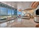 A modern primary bedroom with panoramic views, a sitting area, a round platform bed, and custom wall décor at 4525 Dean Martin Dr # 2503, Las Vegas, NV 89103