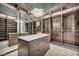 Large walk-in closet with custom shelving, mirrored panels, a center island, and a modern chandelier at 4525 Dean Martin Dr # 2503, Las Vegas, NV 89103