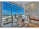 Chic dining area with city views, chandelier, and round table with ornate chairs at 4525 Dean Martin Dr # 2503, Las Vegas, NV 89103
