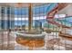 Elegant living area featuring a sculptural staircase, stylish seating, and panoramic city views at 4525 Dean Martin Dr # 2503, Las Vegas, NV 89103