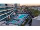 Modern rooftop pool and jacuzzi surrounded by palm trees and contemporary condo buildings at 4525 Dean Martin Dr # 2503, Las Vegas, NV 89103