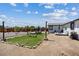 Backyard featuring a hammock, grassy patch with rocks, and outdoor seating area at 4981 E Pawnee Pl, Pahrump, NV 89061