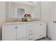 Bathroom vanity with double sinks and white cabinets at 4981 E Pawnee Pl, Pahrump, NV 89061