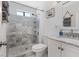 Modern bathroom with tiled walk-in shower and vanity with marble countertop at 4981 E Pawnee Pl, Pahrump, NV 89061