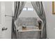 Relaxing bathtub in bathroom, with marble tile and accent lighting at 4981 E Pawnee Pl, Pahrump, NV 89061
