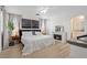 Bright bedroom featuring a decorative fireplace, white bedspread, and a ceiling fan at 4981 E Pawnee Pl, Pahrump, NV 89061